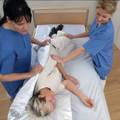 Patient turning aid with handles shown flat on bed