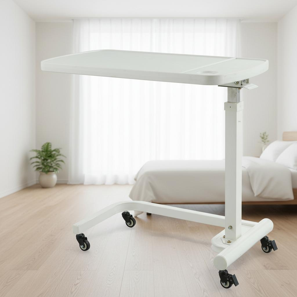 Overbed table with food tray positioned over hospital bed with blue mattress