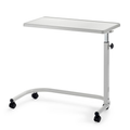 Adjustable overbed table with wooden top and castors next to home bed with food on top