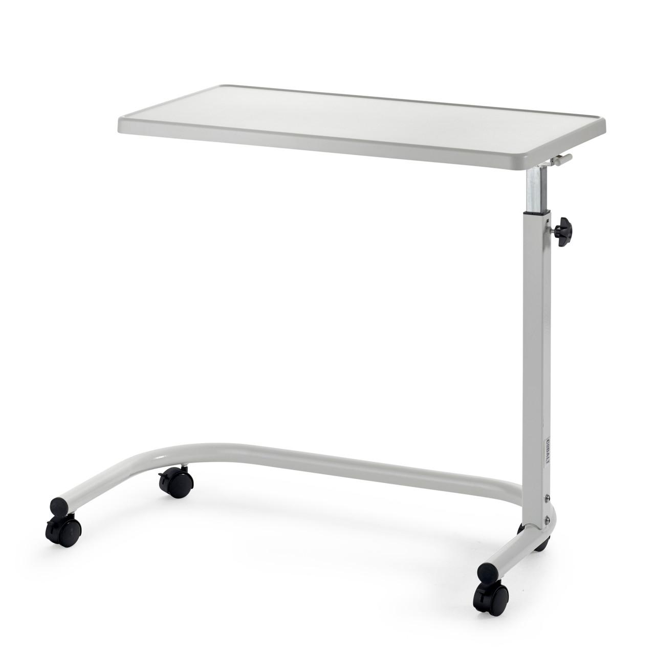 Adjustable overbed table with wooden top and castors next to home bed with food on top