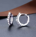 Lumière Pavé Huggie Hoop Earrings – silver micro-pavé zirconia huggies on white background