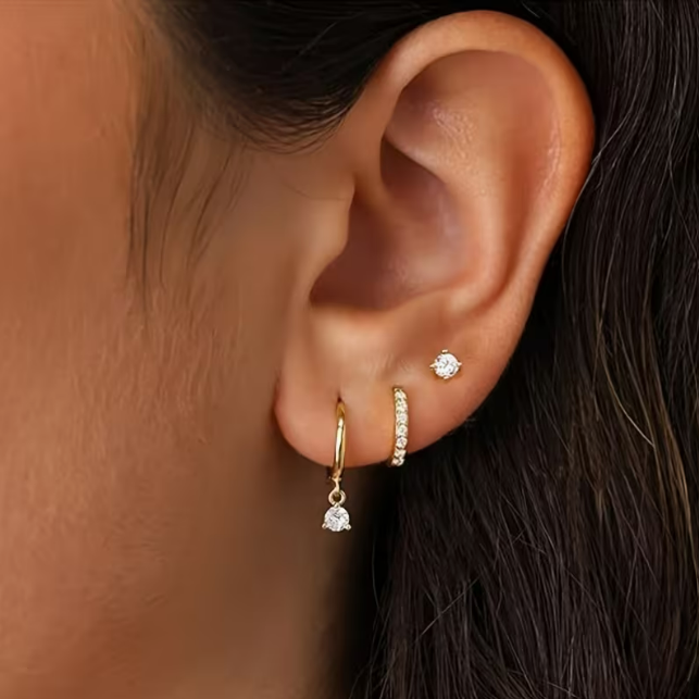 Éclat Dorée 3-Piece Earring Set – gold pavé huggie, crystal drop hoop and zirconia stud worn on ear